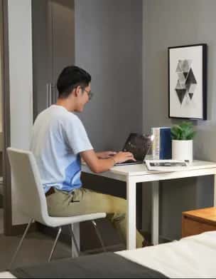 Resident working comfortably from a well-designed room.
