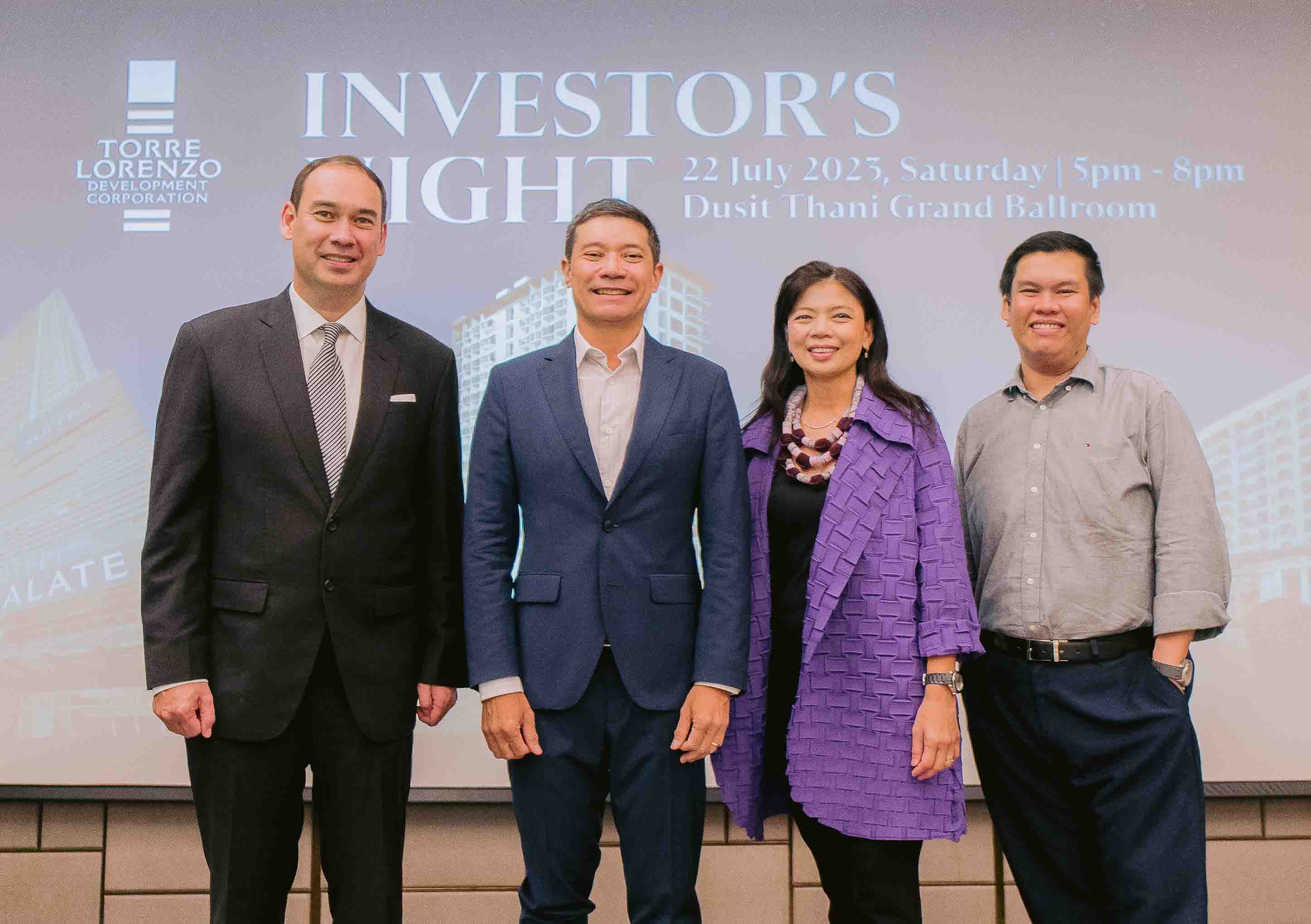 a group of people standing in front of a TLDC investor's night banner
