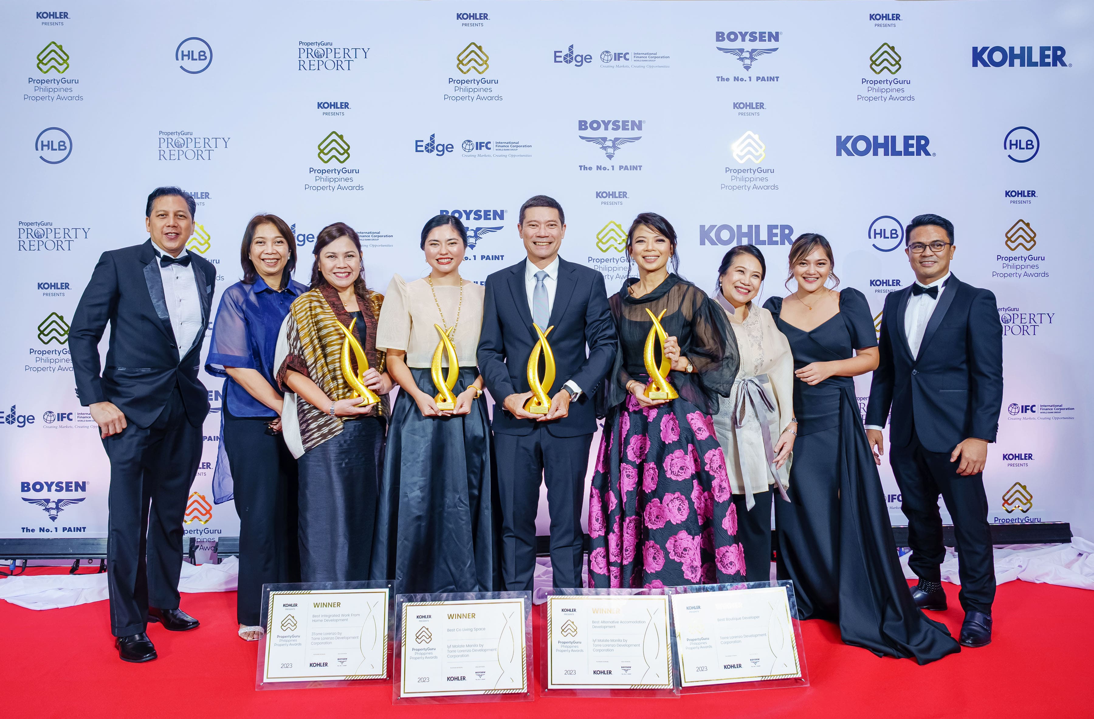 A group of people handling trophies and plaques at the Philippines Property Awards 2023