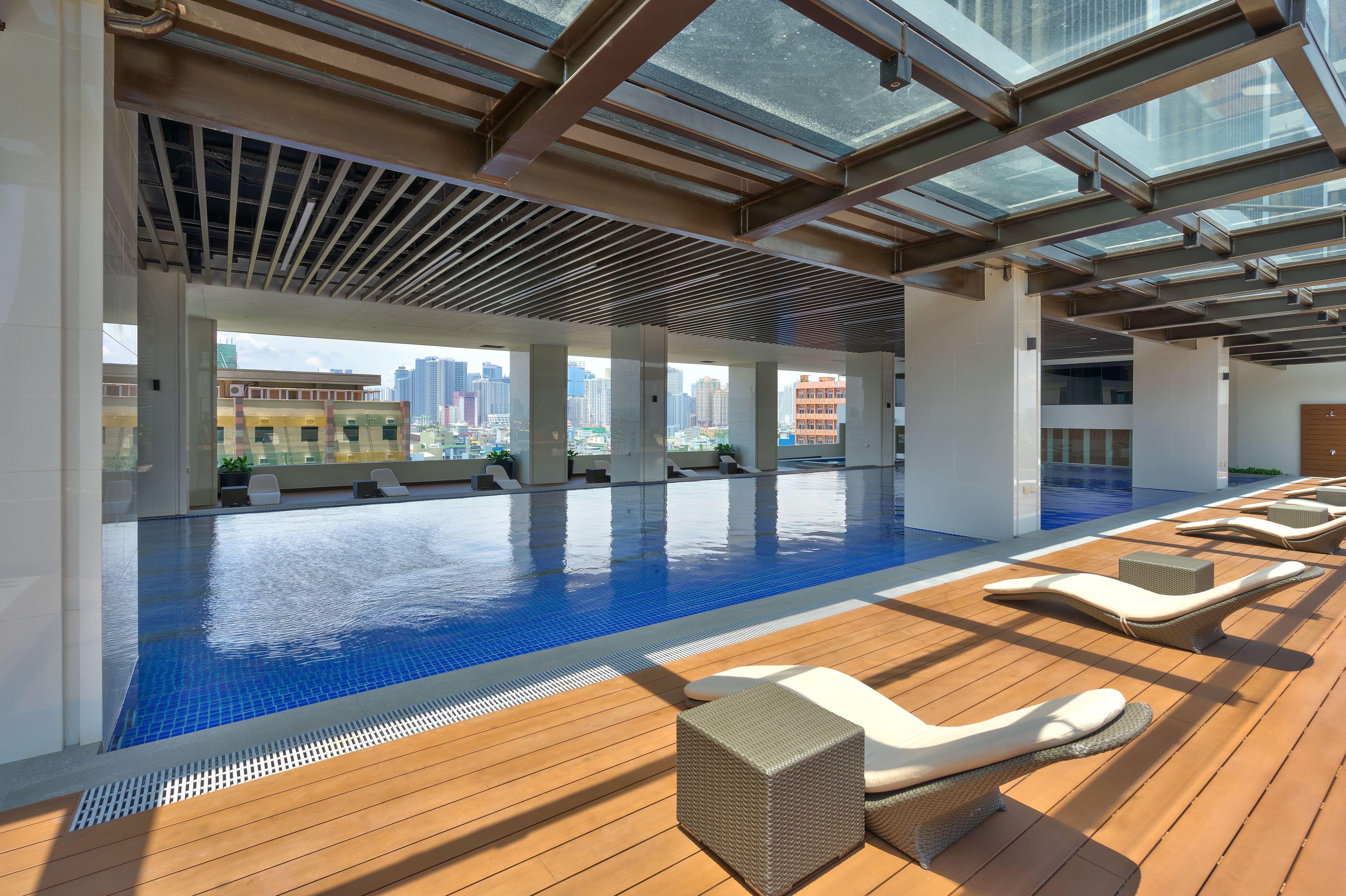 a large pool area in 3Torre Lorenzo with a deck chair and a large roof